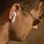 Man wearing wireless earbuds featuring ANC vs ENC noise cancellation technology