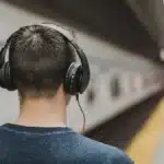 Man wearing wireless earbuds featuring ANC vs ENC noise cancellation technology