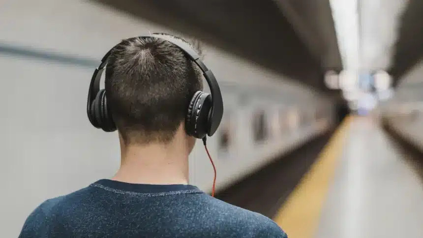 Man wearing wireless earbuds featuring ANC vs ENC noise cancellation technology
