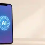 A smartphone displaying a glowing AI brain icon on its screen illustrating how AI transformed smartphones