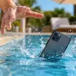 Smartphone falling into swimming pool illustrating IP68 water resistance