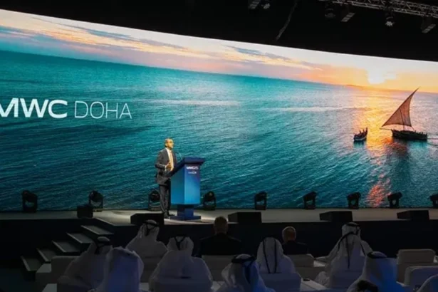 MWC26 Doha conference stage with a speaker and MWC Doha branding on a large screen