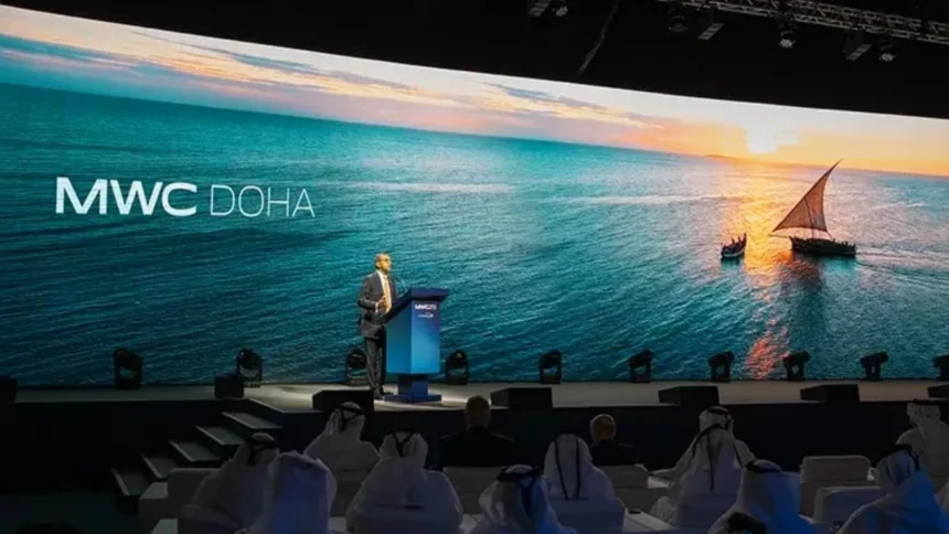 MWC26 Doha conference stage with a speaker and MWC Doha branding on a large screen